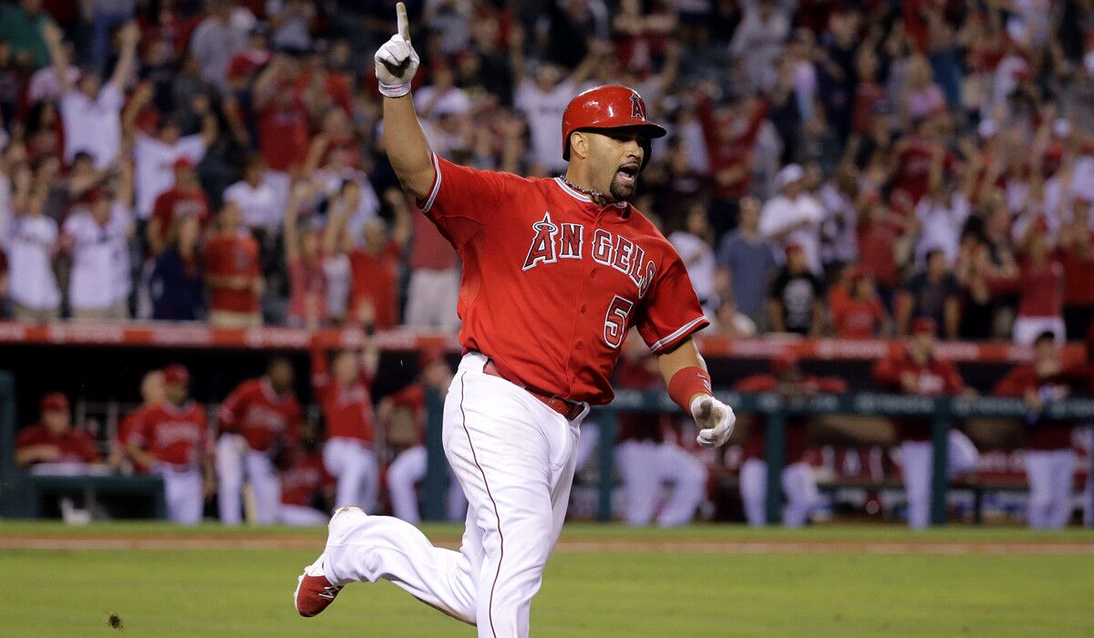 Angles third baseman Albert Pujols celebrates his walk-off home run in the 19th inning of a 5-4 victory over the Boston Red Sox on Saturday night.