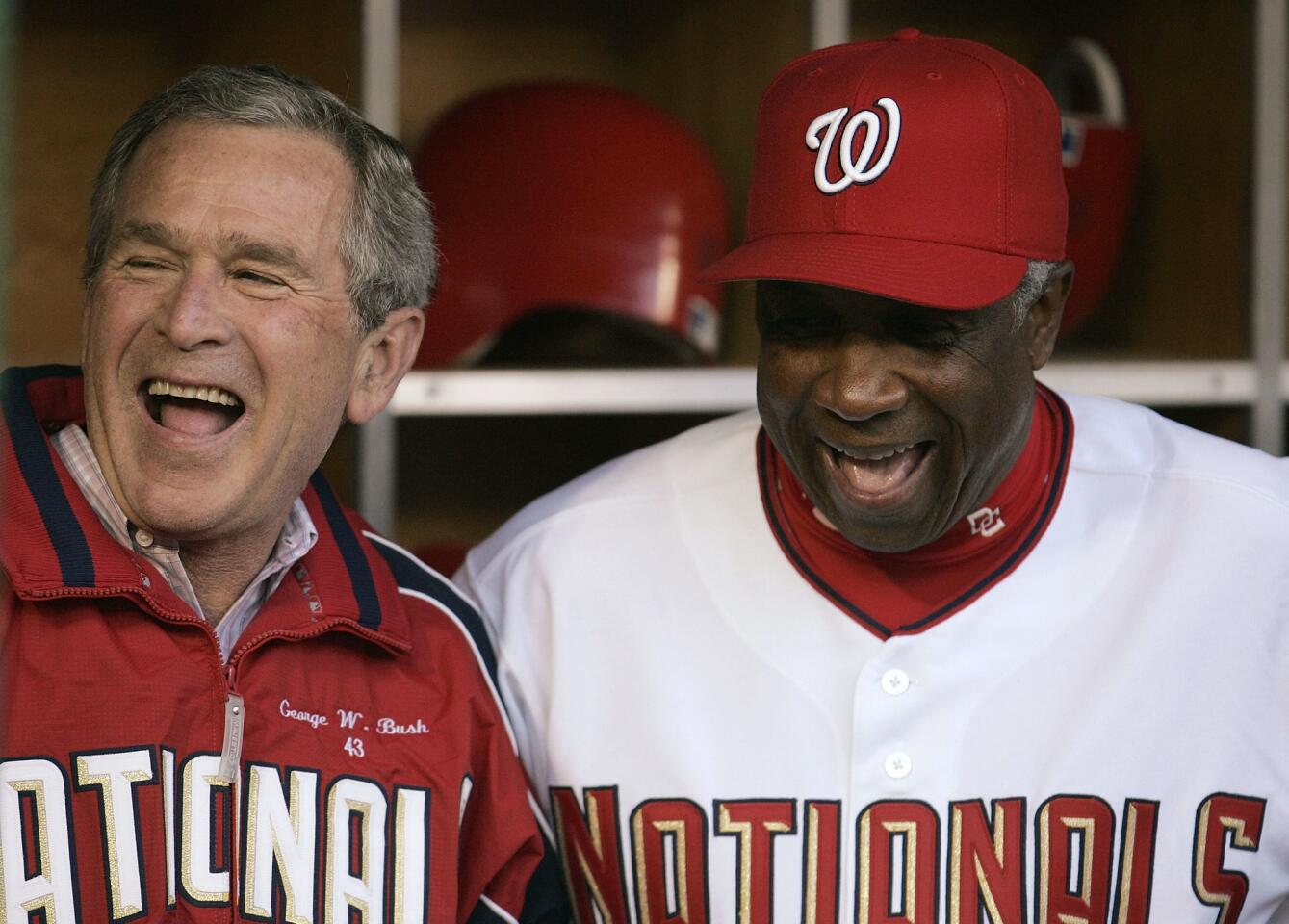 President George W. Bush shares a laugh with Nationals manager Frank Robinson before throwing out the first pitch at the Washington Nationals' home opener against the Arizona Diamondbacks at RFK Stadium on April 14, 2005, in Washington.