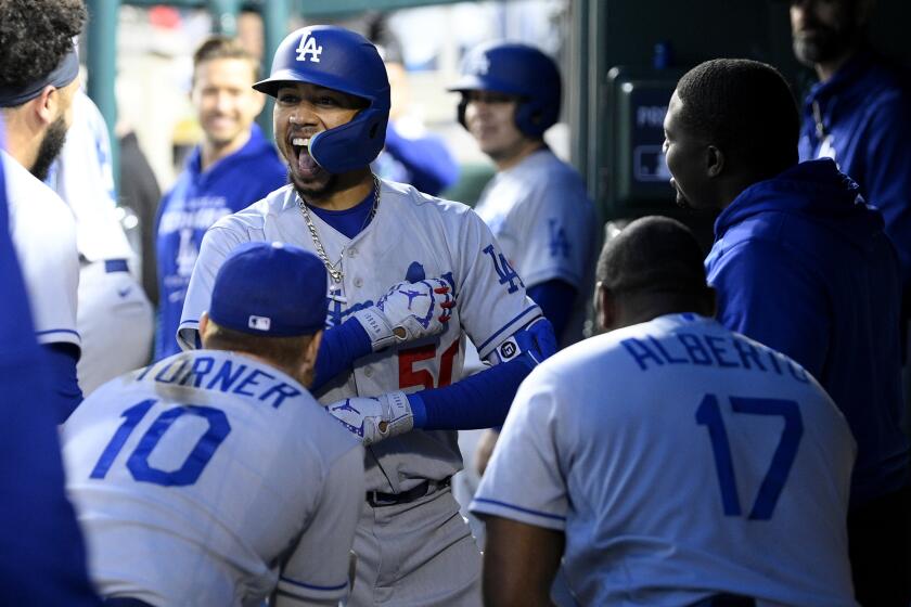 Los Angeles Dodgers' Mookie Betts celebrates his home run with Justin Turner (10), Hanser Alberto (17) and others during the fourth inning of a baseball game against the Washington Nationals, Tuesday, May 24, 2022, in Washington. (AP Photo/Nick Wass)