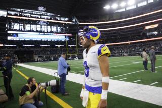 Rams quarterback Matthew Stafford walks off the field against Dallas with his injured right thumb bandaged.