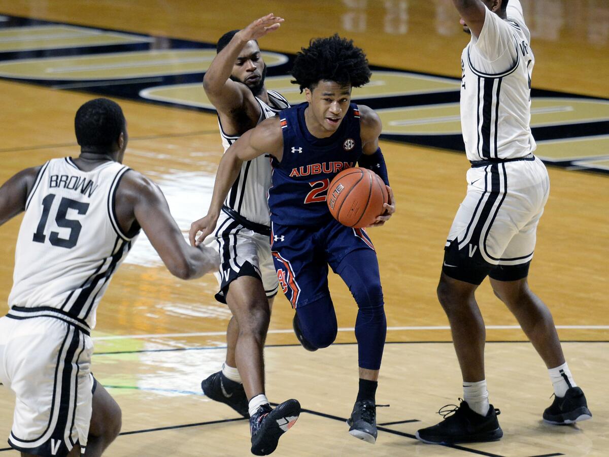 Auburn guard Sharife Cooper drives through the defense of Vanderbilt.