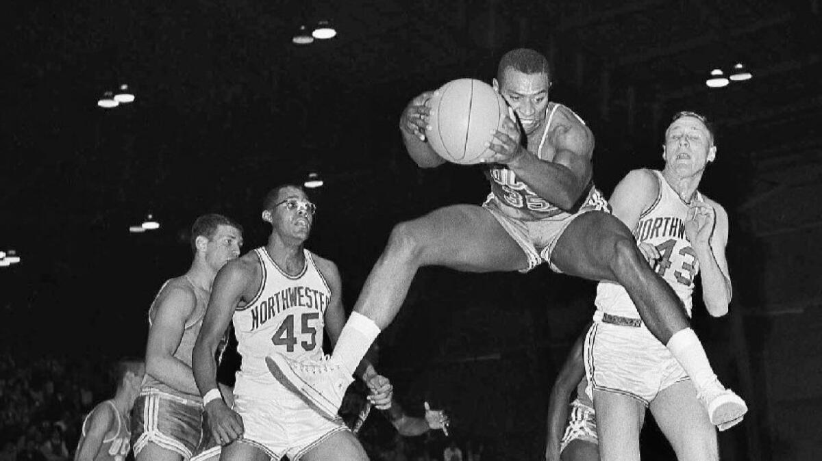 UCLA's Fred Slaughter leaps to grab a rebound during a game against Northwestern in 1962.