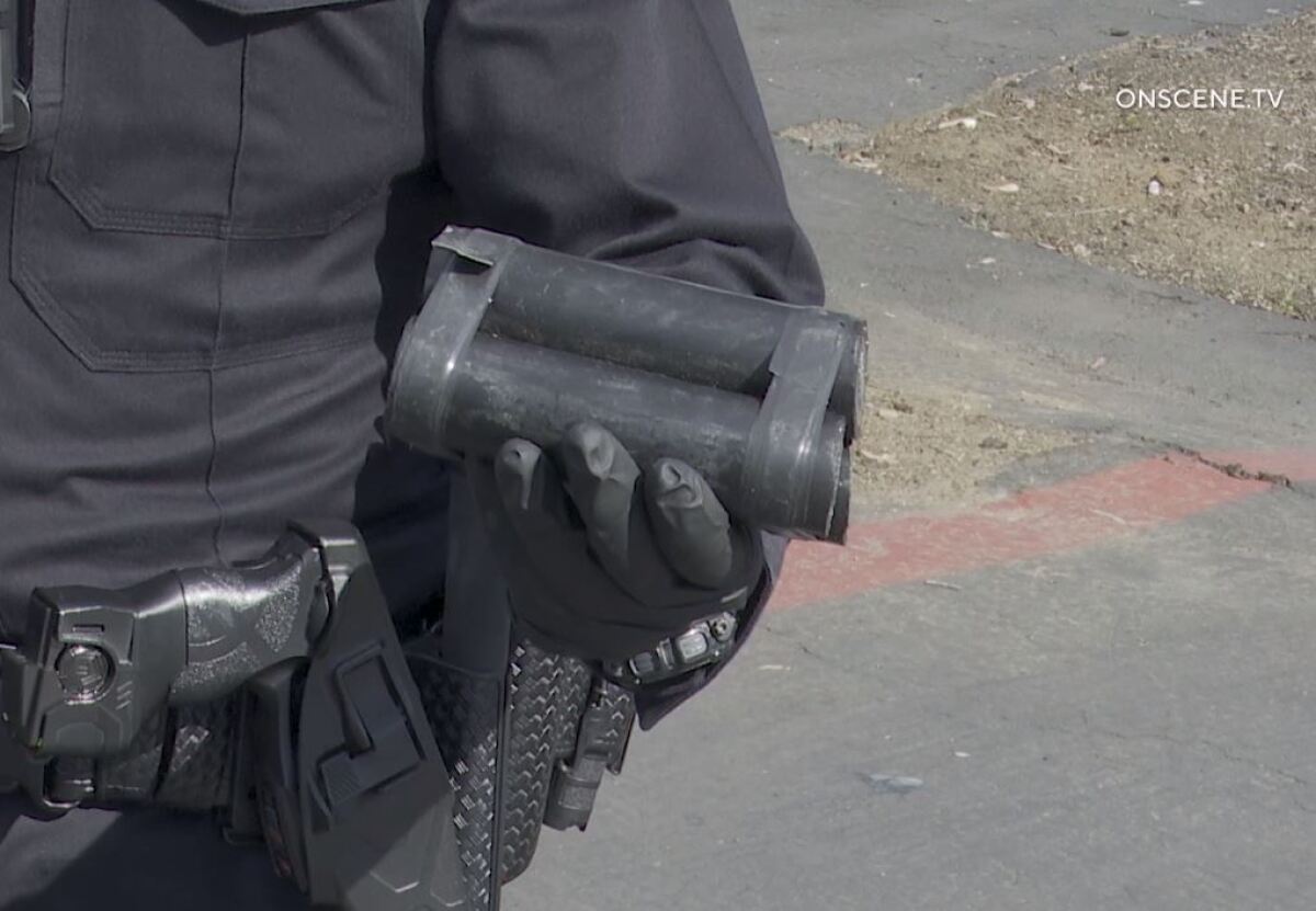 A National City police officer displays the item that prompted a bomb scare Monday morning in a business district off Mile of Cars Way and Hoover Avenue.