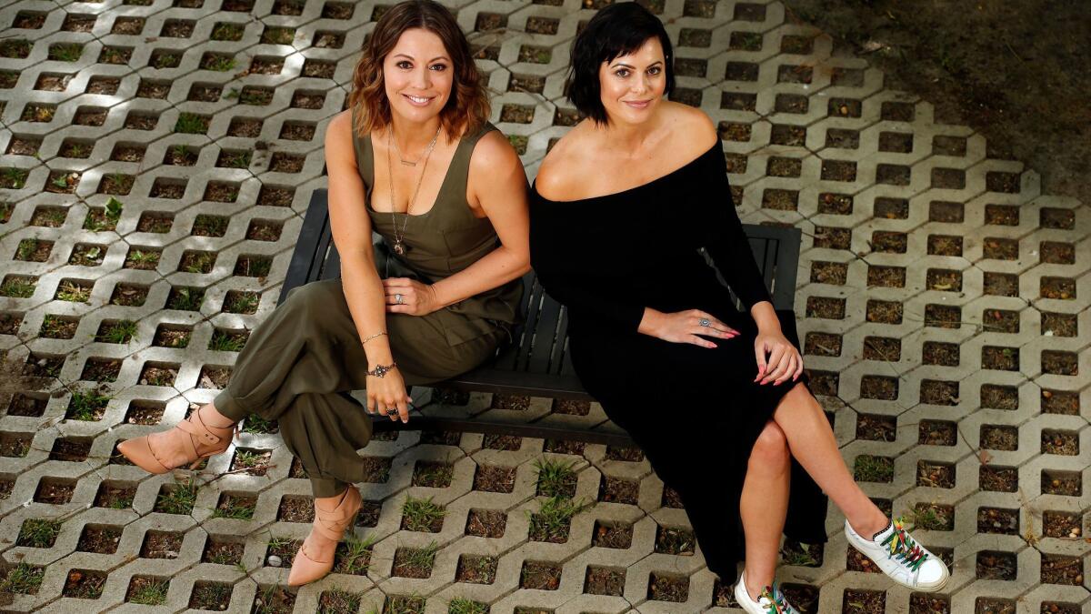 Kay Cannon, left, executive producer and showrunner of the new Netflix series "Girlboss," and Sophia Amoruso, who wrote the bestselling book, "#Girlboss," that the series is based on, at Cannon's home in Studio City.