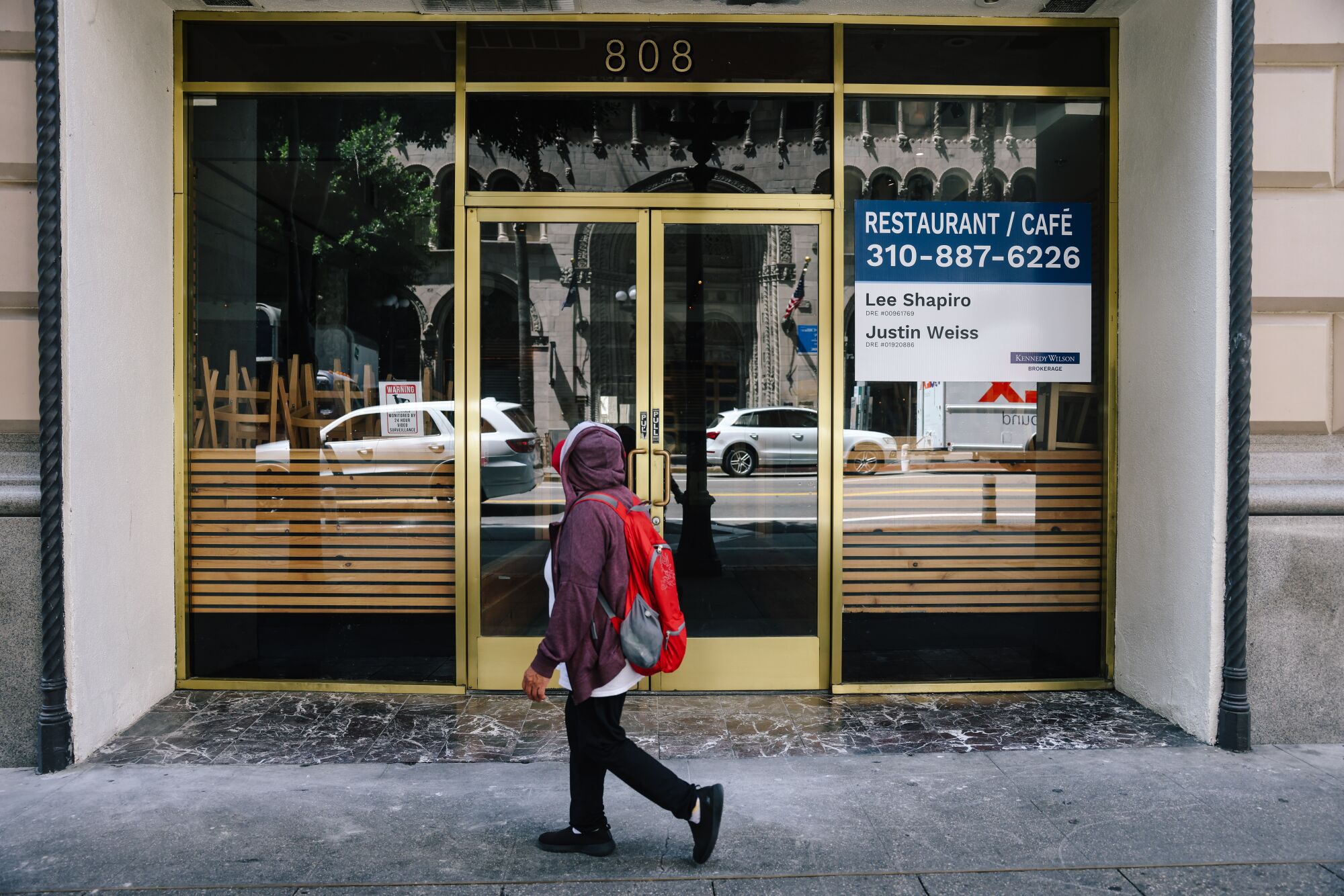 A person passes an establishment for rent downtown on Thursday, April 27, 2023 in Los Angeles, CA.