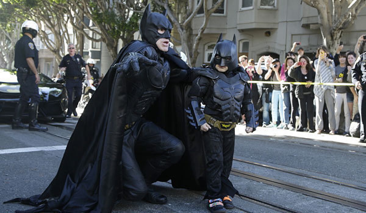Batman, left, advises 5-year-old Miles, a.k.a. Batkid, on the gritty streets of Gotham, a.k.a. San Francisco.