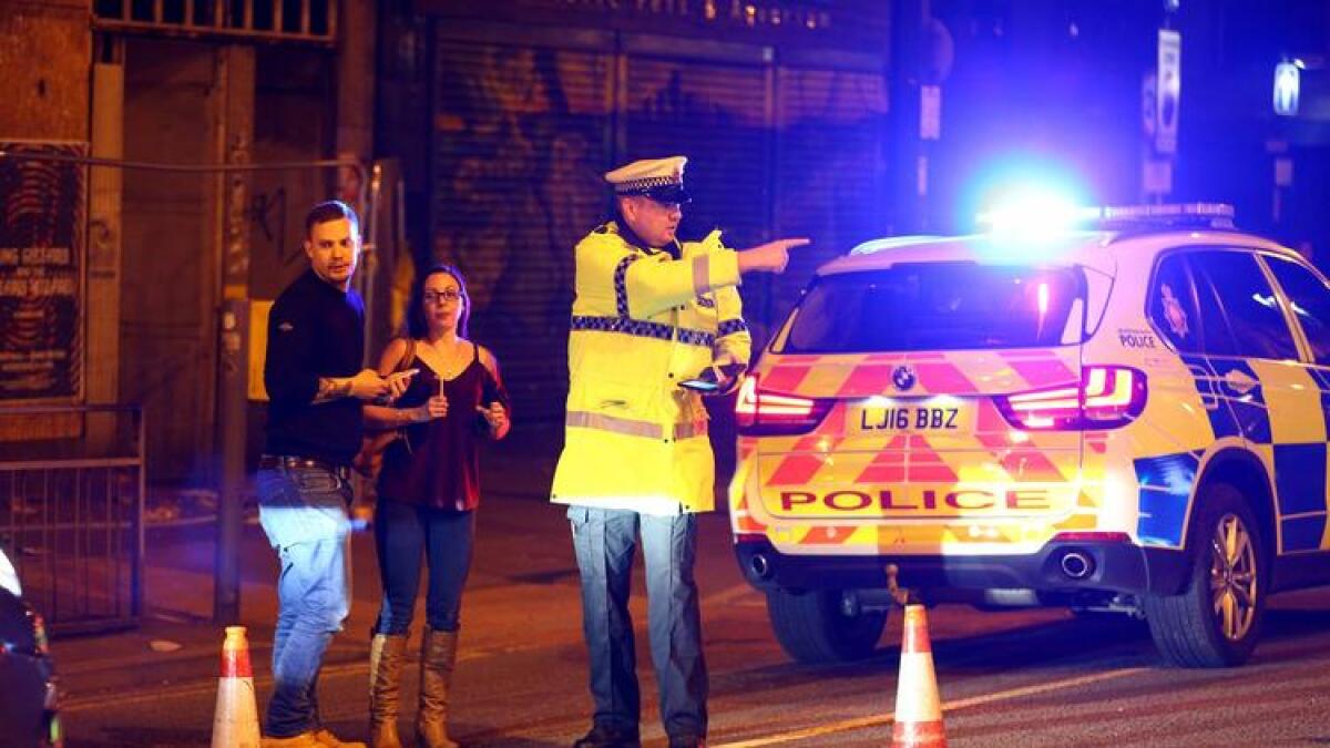 Police stand by a cordoned-off street close to the Manchester Arena on May 22 in Manchester, England.