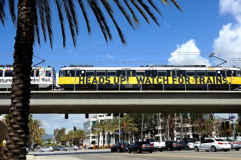 A train rides over a bridge to the 26th Street/Bergamot station in Santa Monica.