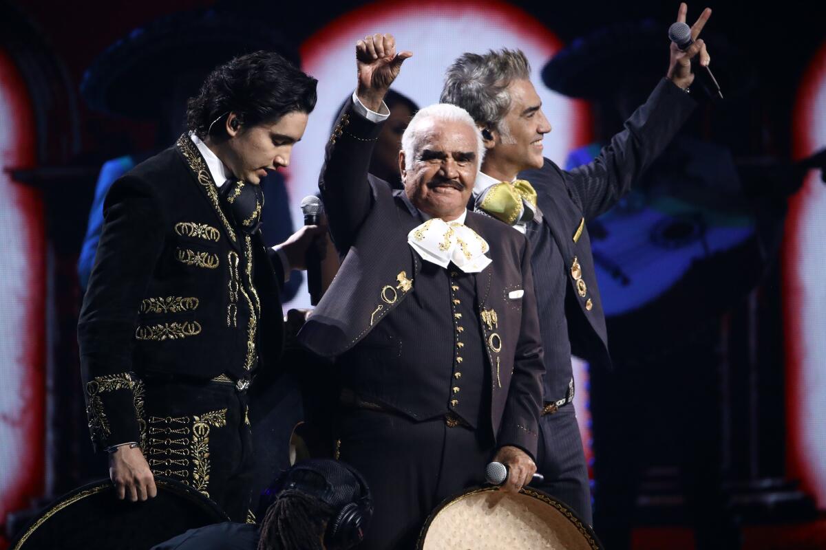  Alex Fernandez, Vicente Fernandez and Alejandro Fernández perform onstage in full mariachi garb