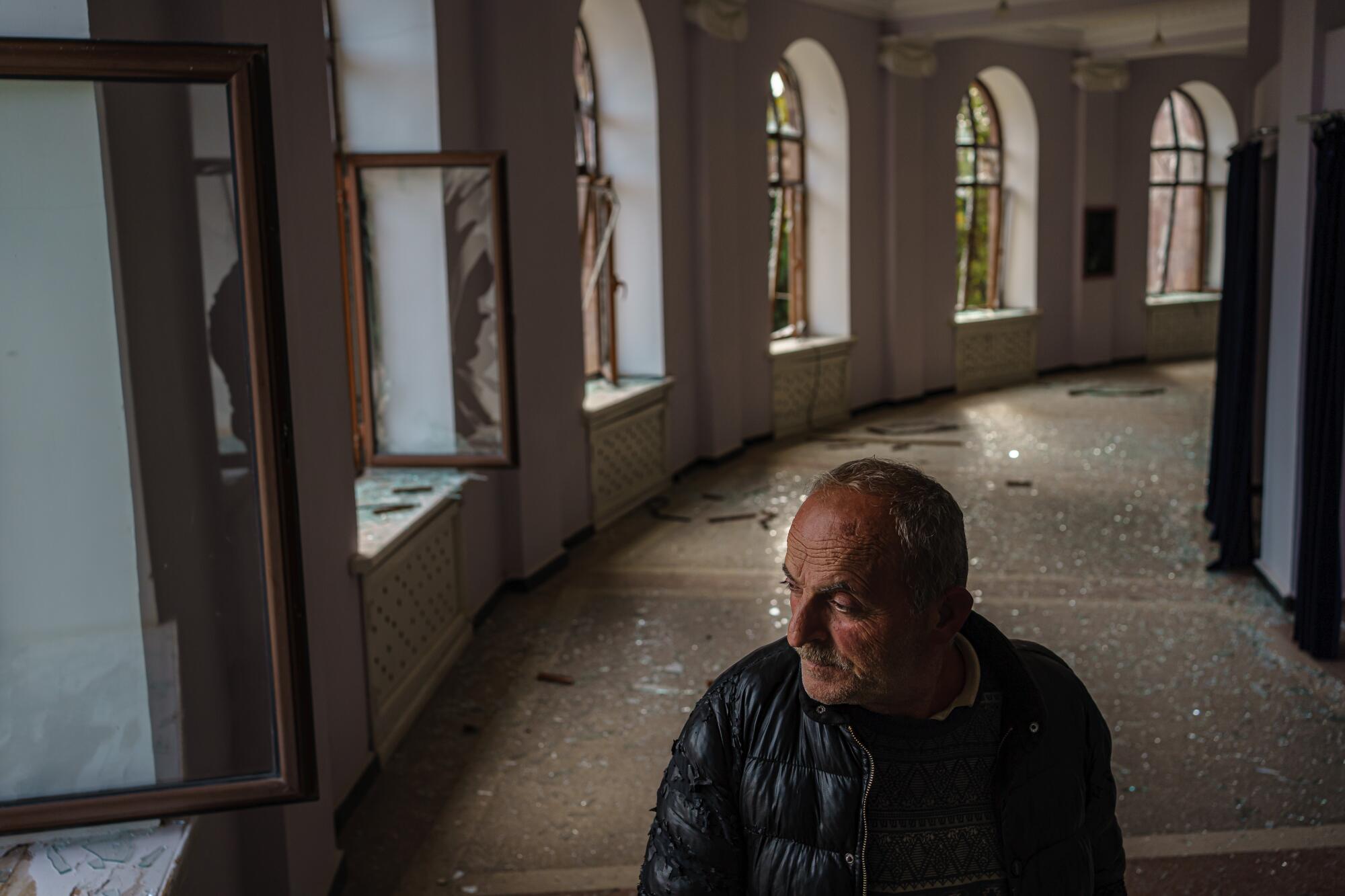 Leonard Hovanissian, 61, stands in the theater in Martuni, whose windows were blown out in a military strike.