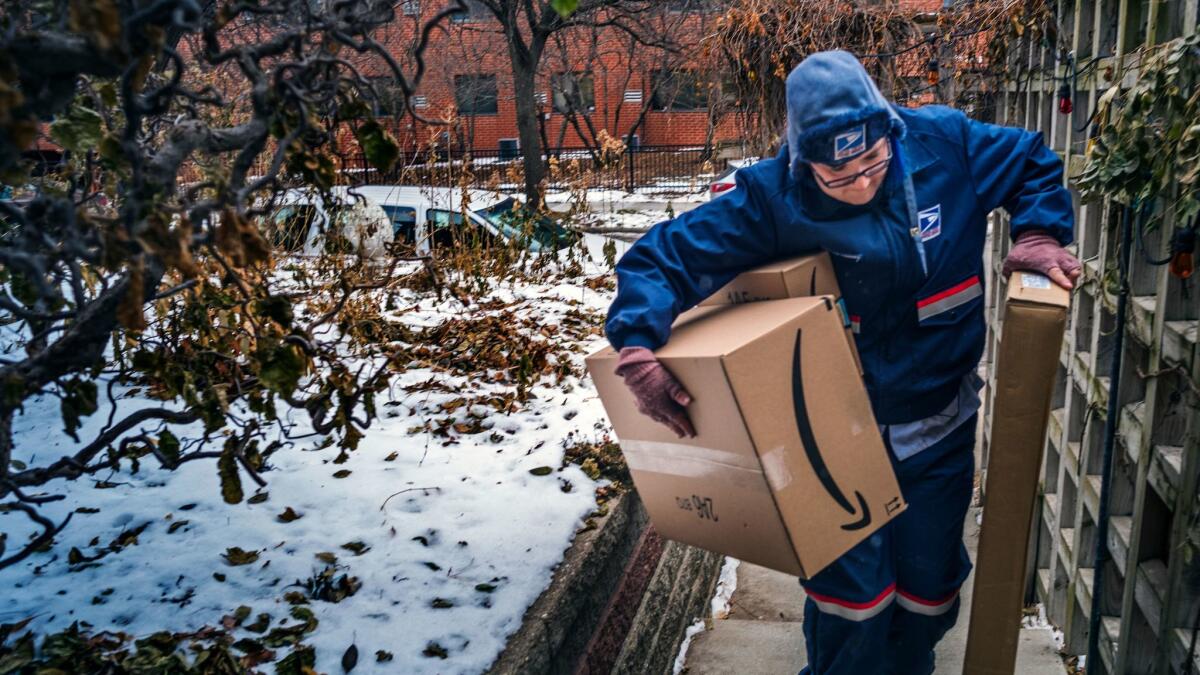 United States Postal Service worker Missie Kittok braves the Midwestern pre-Christmas deep freeze to deliver Amazon packages in Minneapolis.