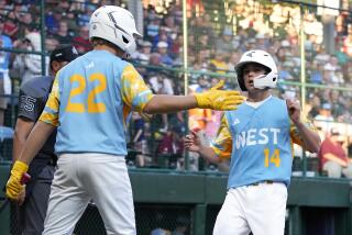 El Segundo, Calif.'s Brody Brooks is greeted by Jaxon Kalish after scoring on a wild pitch.