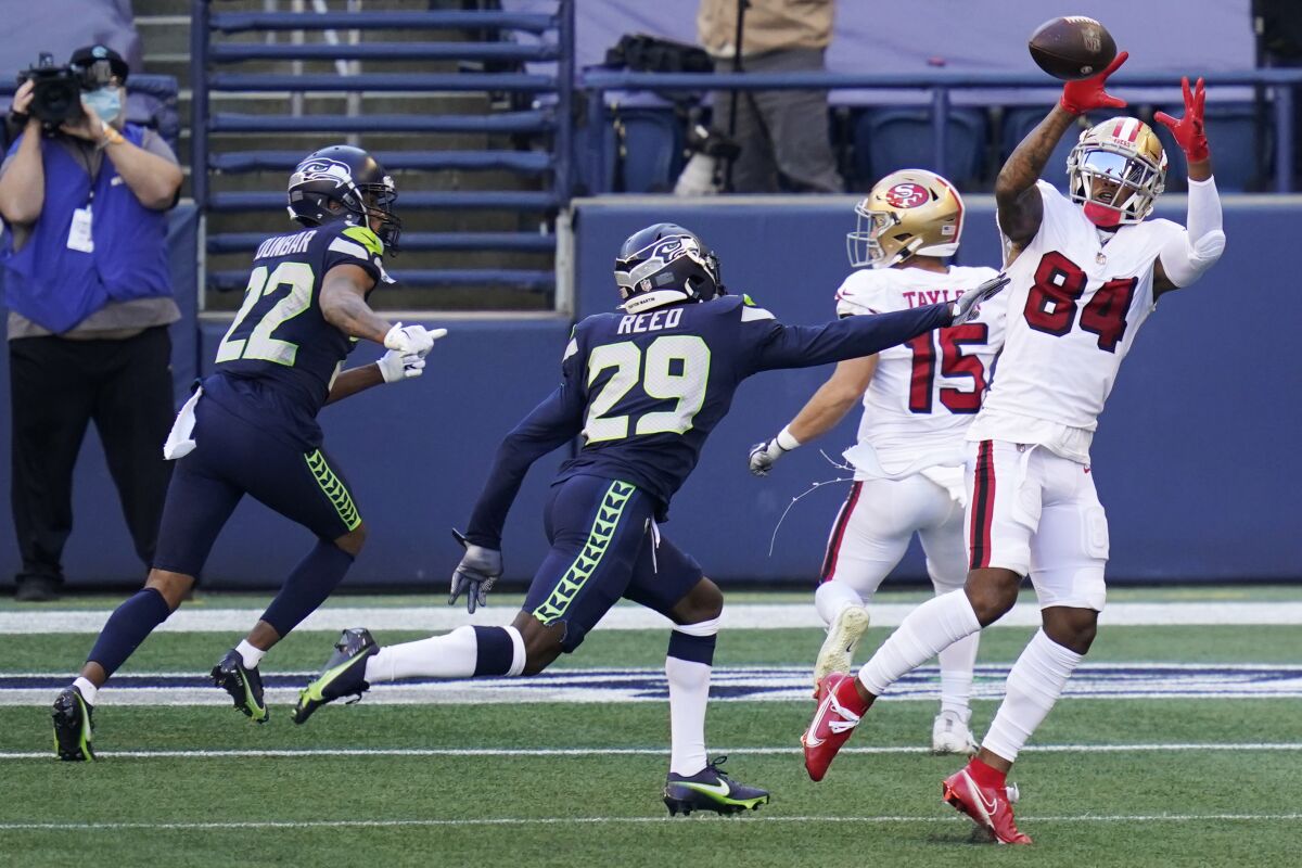 San Francisco 49ers wide receiver Kendrick Bourne (84) makes a catch in front of Seattle Seahawks defensive back Jayson Stanley (29) during the first half of an NFL football game, Sunday, Nov. 1, 2020, in Seattle. (AP Photo/Elaine Thompson)