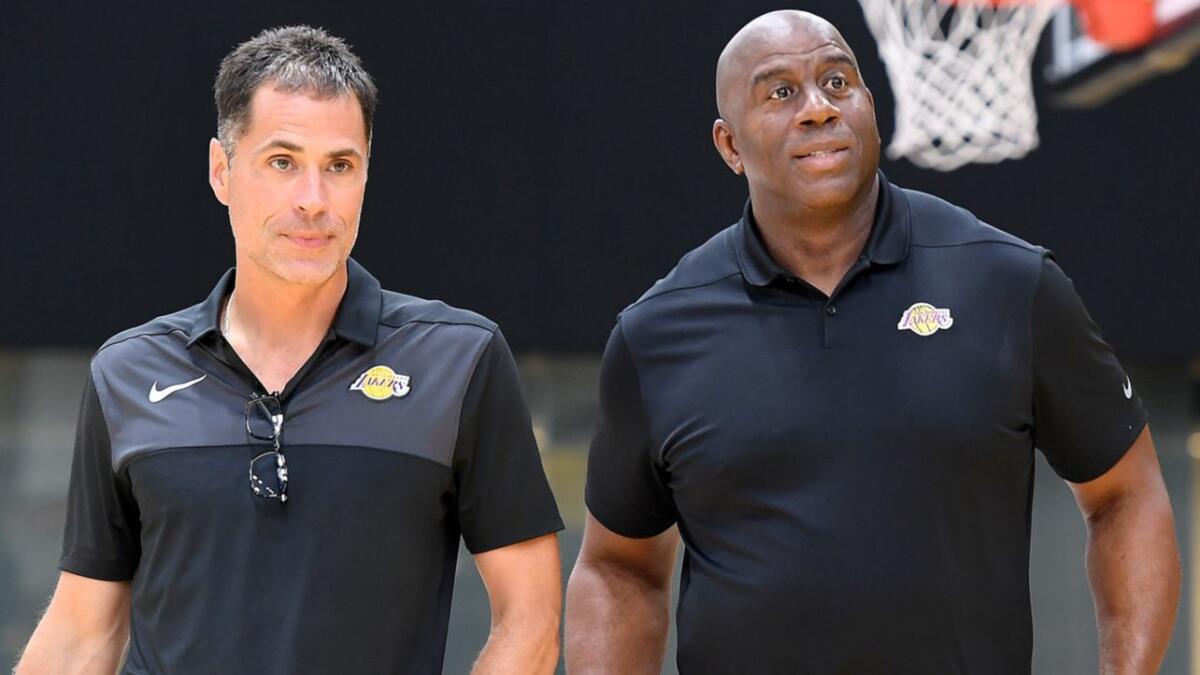 Lakers general manager Rob Pelinka, left, and president of basketball operations Magic Johnson prepare for a news conference Sept. 20 in El Segundo.