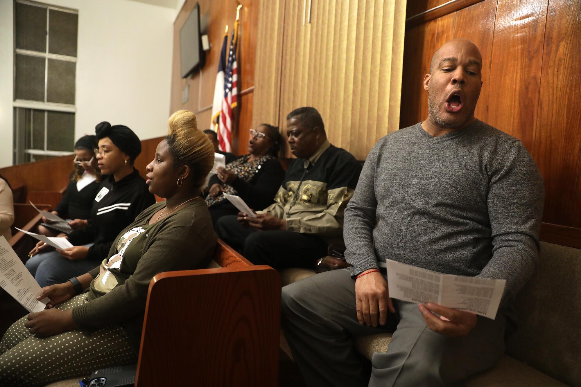 Xerik Bell, right, and other members of the Victory Baptist Church sing during a rehearsal.