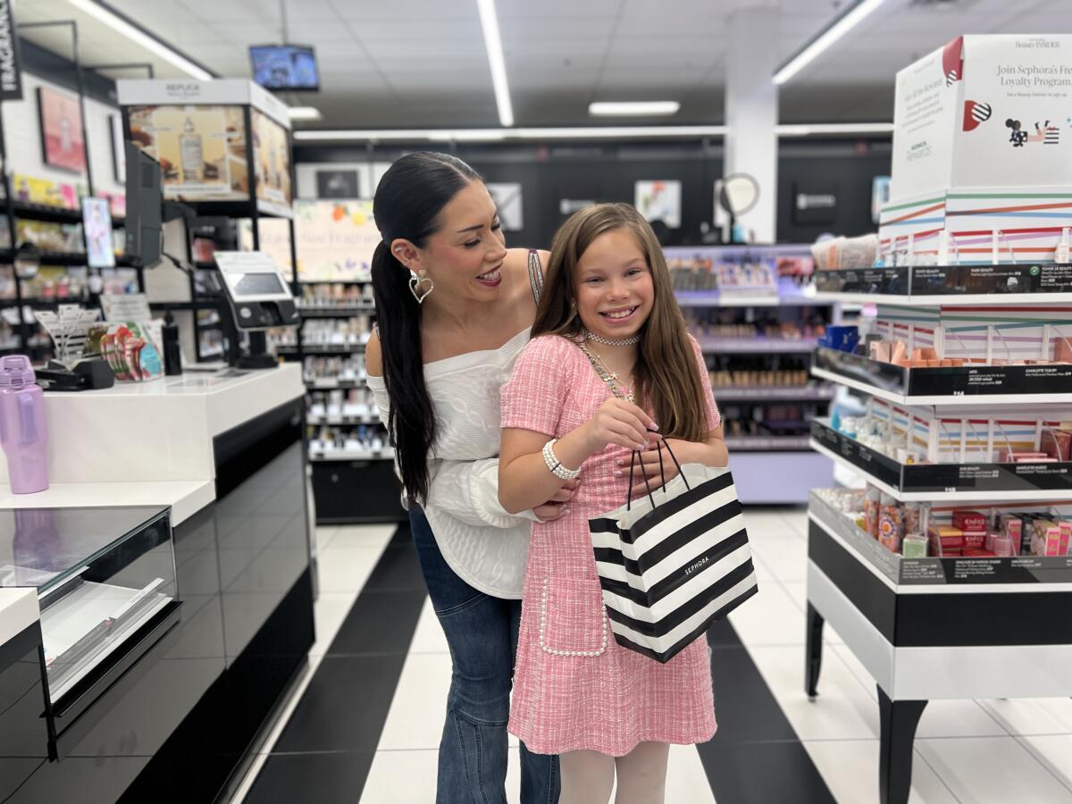 Ashley Paige, 37, left, and her daughter, 10-year-old Naiya White, at a Sephora store.