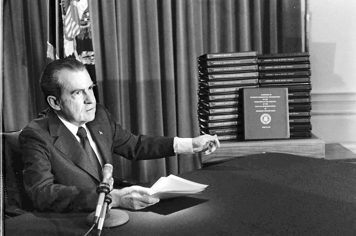President Nixon with stacks of transcripts of the White House tapes in an April 29, 1974, address.