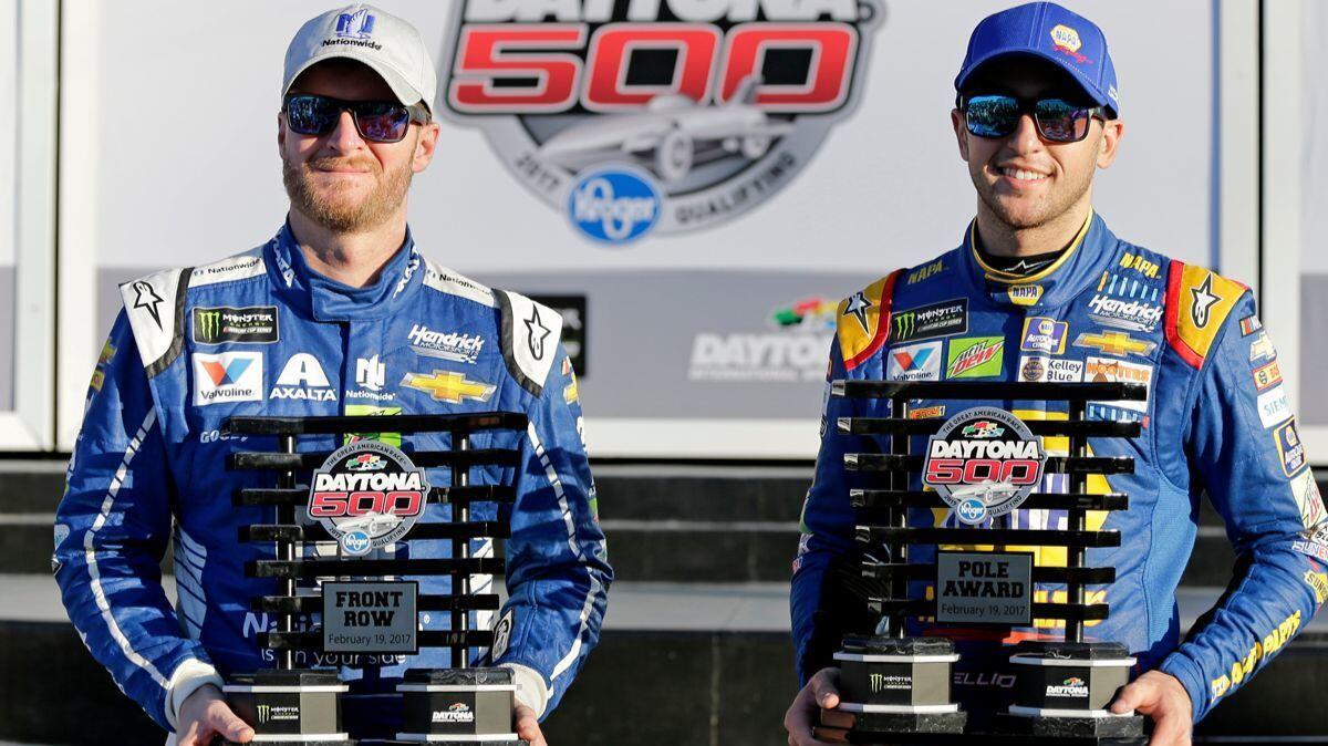 Dale Earnhardt Jr., left, and Chase Elliott display their front row trophies after qualifying for the top two positions in the NASCAR Daytona 500 auto race on Sunday.