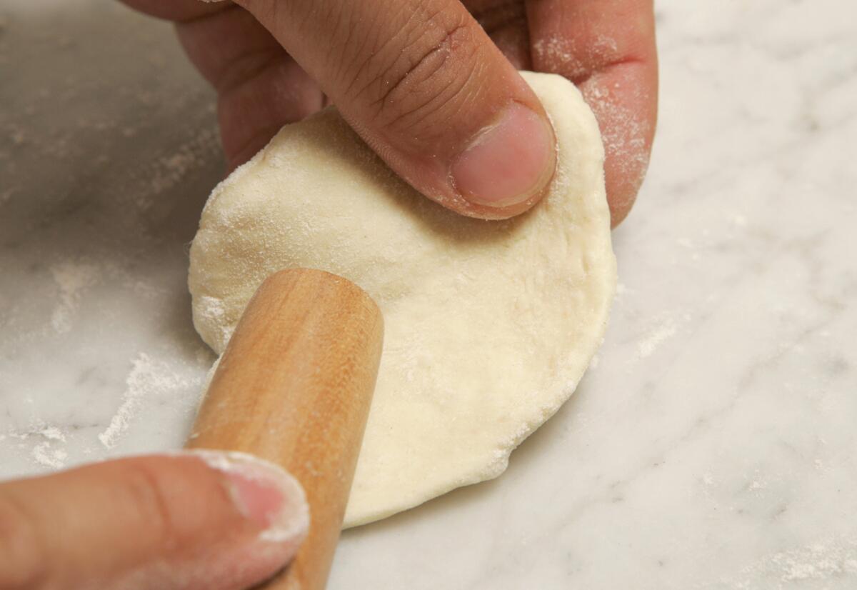 Make a circle, thinner at the edges and thicker in the center, with a small, tapered rolling pin.