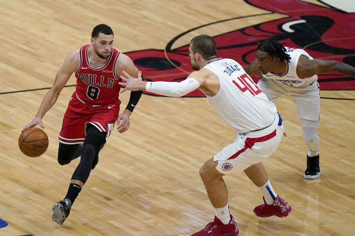 The Clippers' Ivica Zubac (40) and Terance Mann defend Chicago Bulls ballhandler Zach LaVine on Feb. 12, 2021.
