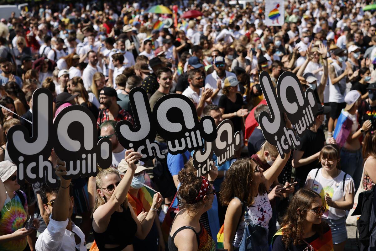 People gather for the Zurich Pride parade in Zurich, Switzerland, Saturday, Sept. 4, 2021. On Sept. 26, 2021 Swiss citizens will vote on the proposal of 'Marriage for everyone' (Ehe fuer alle), allowing marriage for same-sex couples. (Michael Buholzer/Keystone via AP)