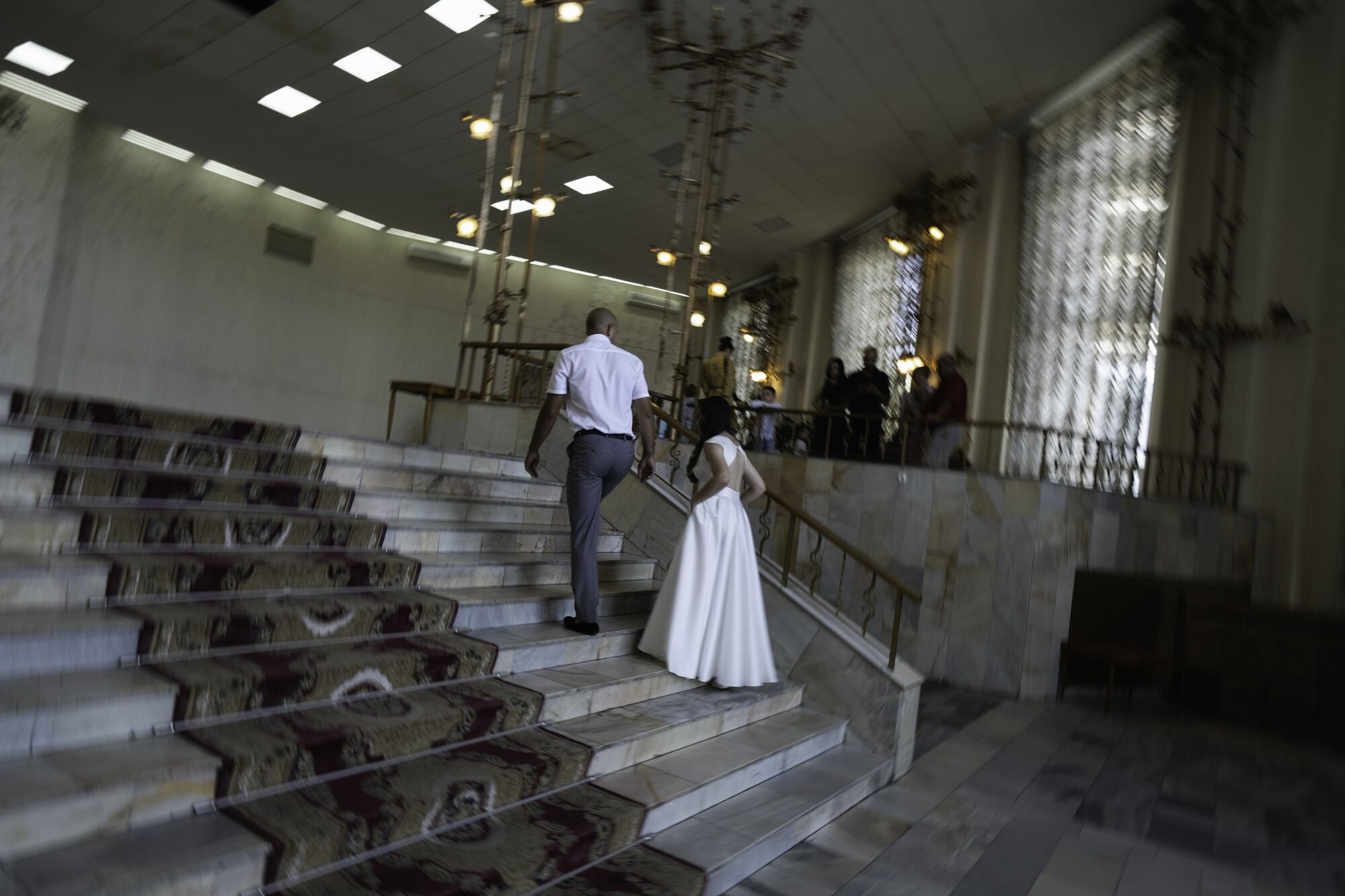 A couple climbs a staircase to get married at the registry office