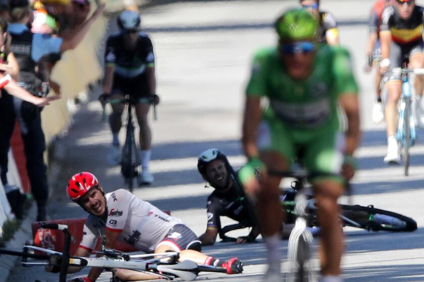 Germany's John Degenkolb, left, and Britain's Mark Cavendish crash during the sprint of the fourth stage of the Tour de France cycling race over 207.5 kilometers (129 miles) with start in Mondorf-les-Bains, Luxembourg, and finish in Vittel, France, Tuesday, July 4, 2017. (AP Photo/Christophe Ena)