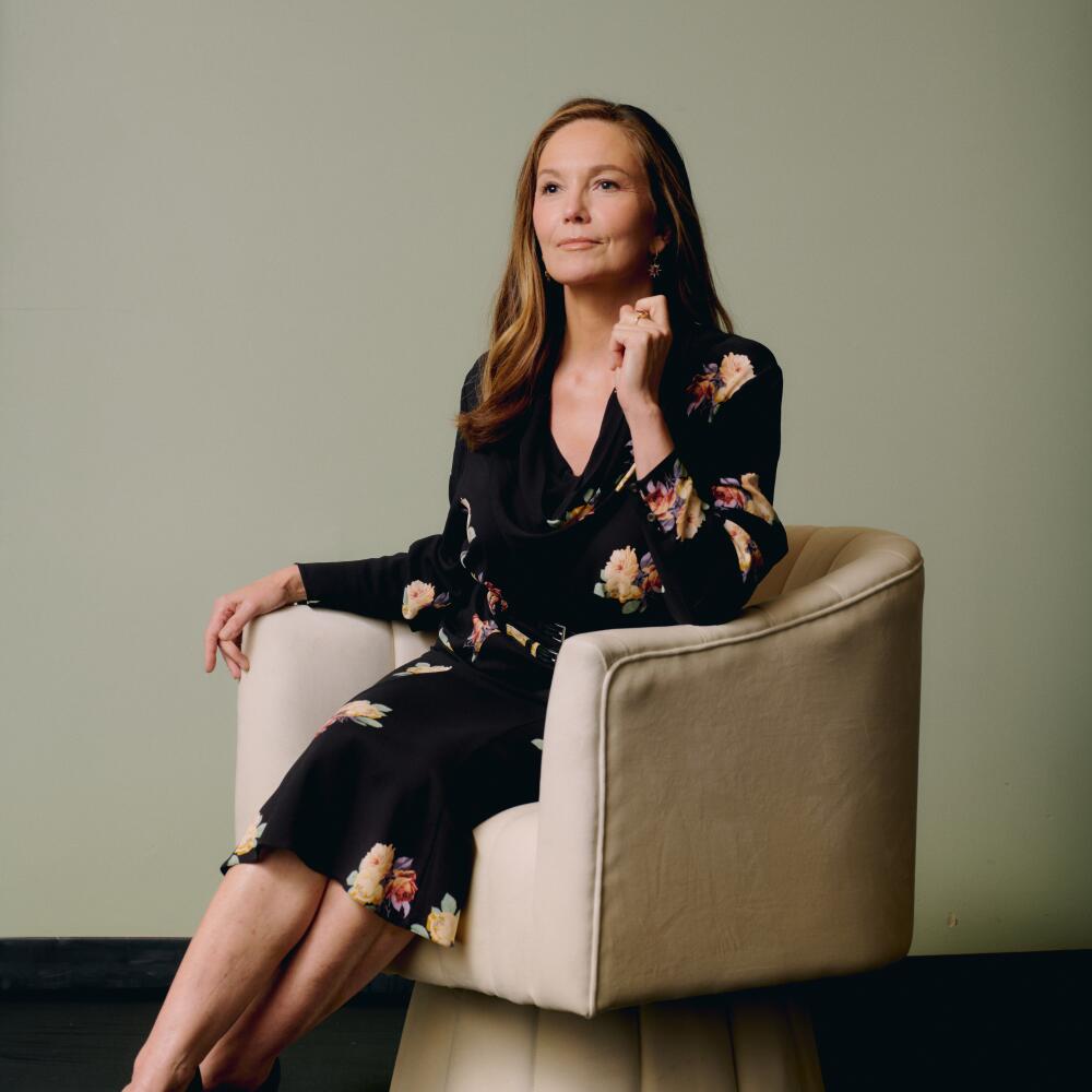 Diane Lanesits in a plush swivel chair for a portrait.