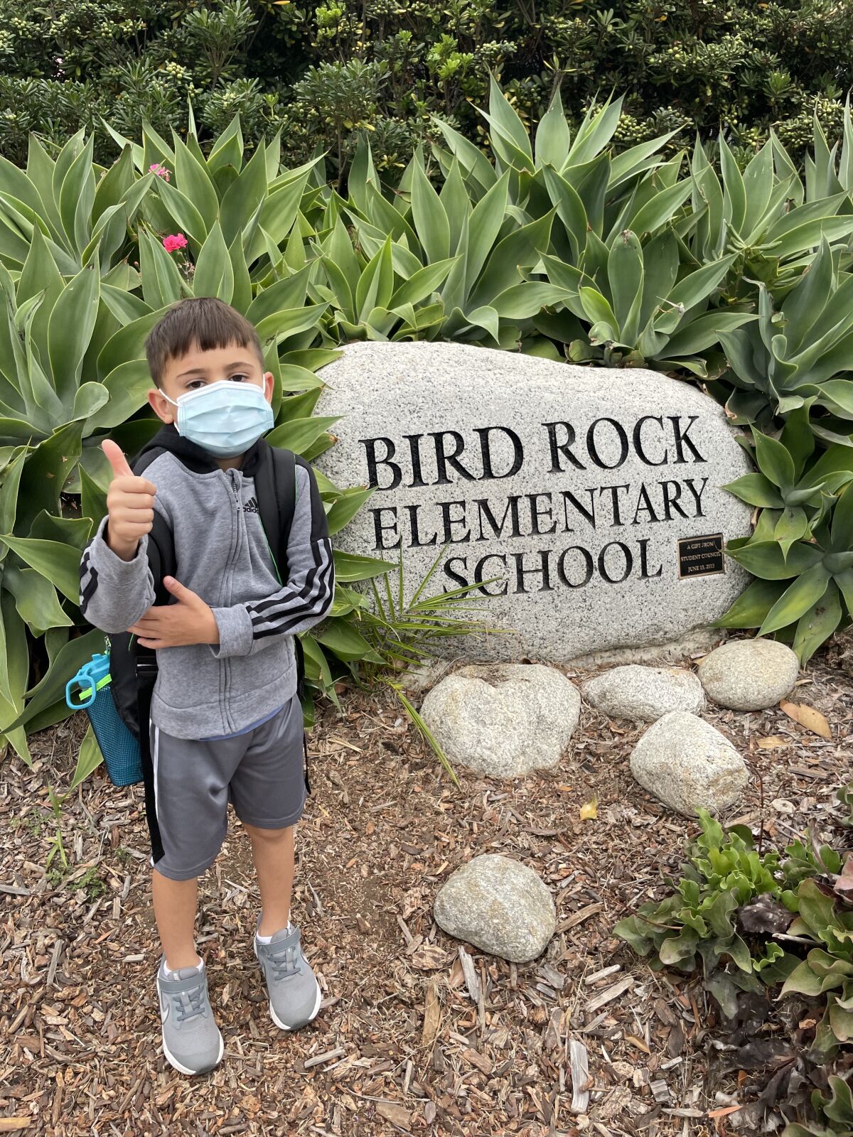Kindergartner Michael Lipkovicius signals he's ready for Bird Rock Elementary School.
