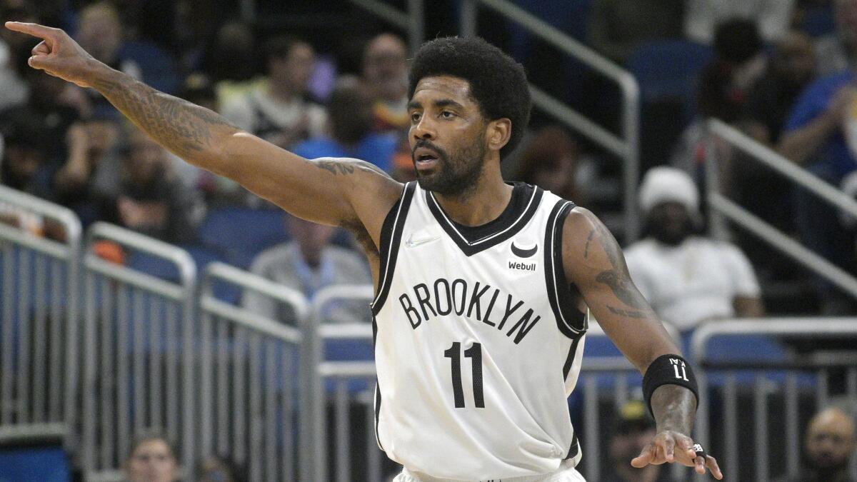 Brooklyn Nets guard Kyrie Irving gestures during a game against the Orlando Magic in March.