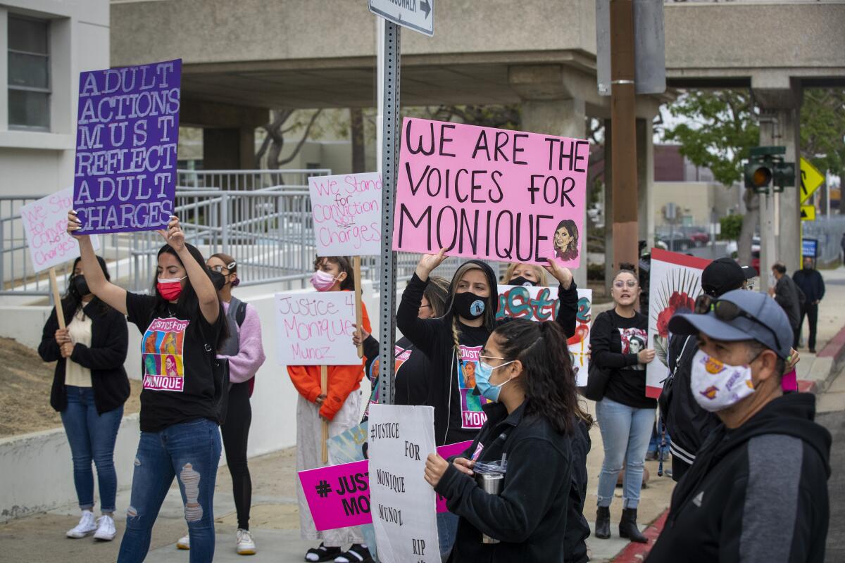 People hold signs calling for justice