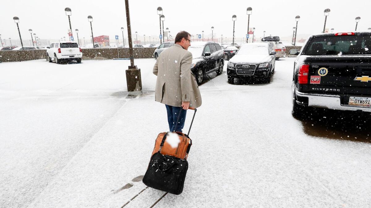 Snow covers Atlanta's Hartsfield-Jackson International Airport, where hundreds of flights were canceled Friday.