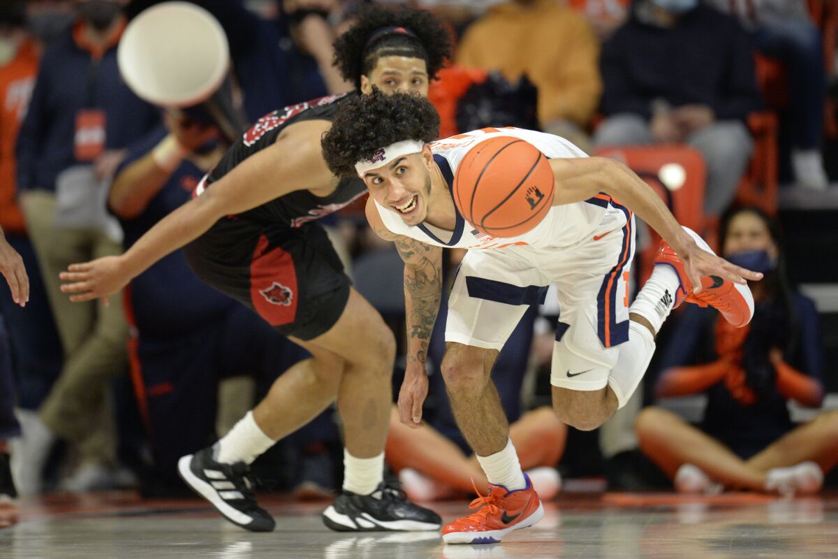 Illinois' Andre Curbelo eyes a loose ball during the first half of an NCAA college basketball game against Arkansas State Friday, Nov. 12, 2021, in Champaign, Ill. (AP Photo/Michael Allio)