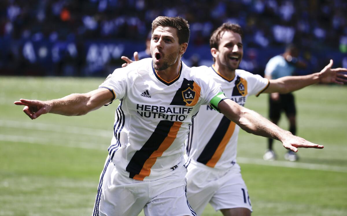 Steven Gerrard, left, celebrates a May 8 goal with Galaxy teammate Mike Magee.
