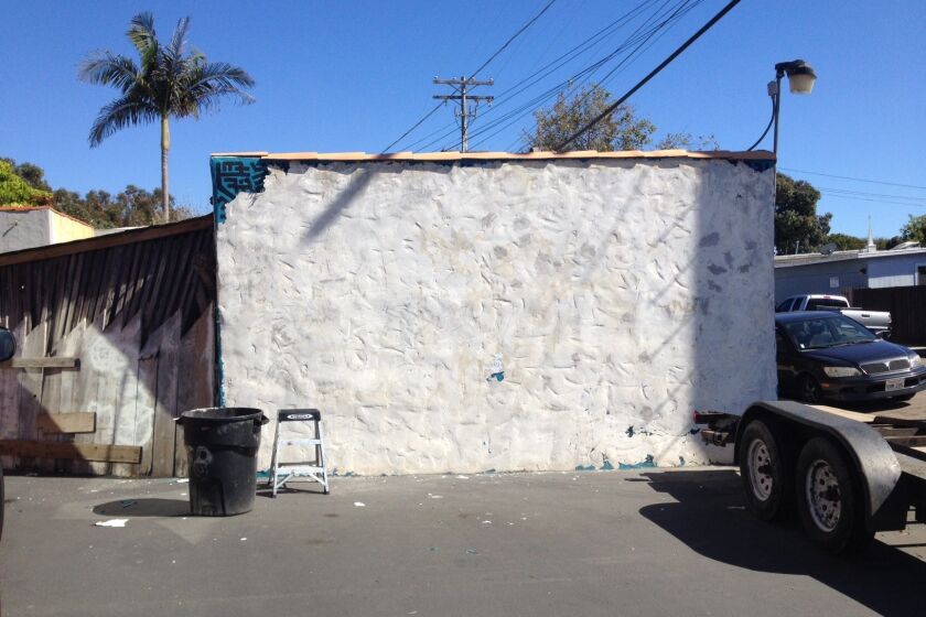 The bare north wall behind Leucadia Glass after being stripped of the acrylic paint that made up the second distinctive mural by Bleu Avina.