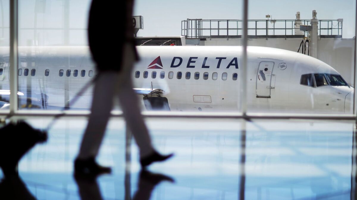 A Delta Air Lines jet sits at a gate at Hartsfield-Jackson Atlanta International Airport in Atlanta. A study from Columbia University says that too much business travel can lead to anxiety, depression and trouble sleeping.