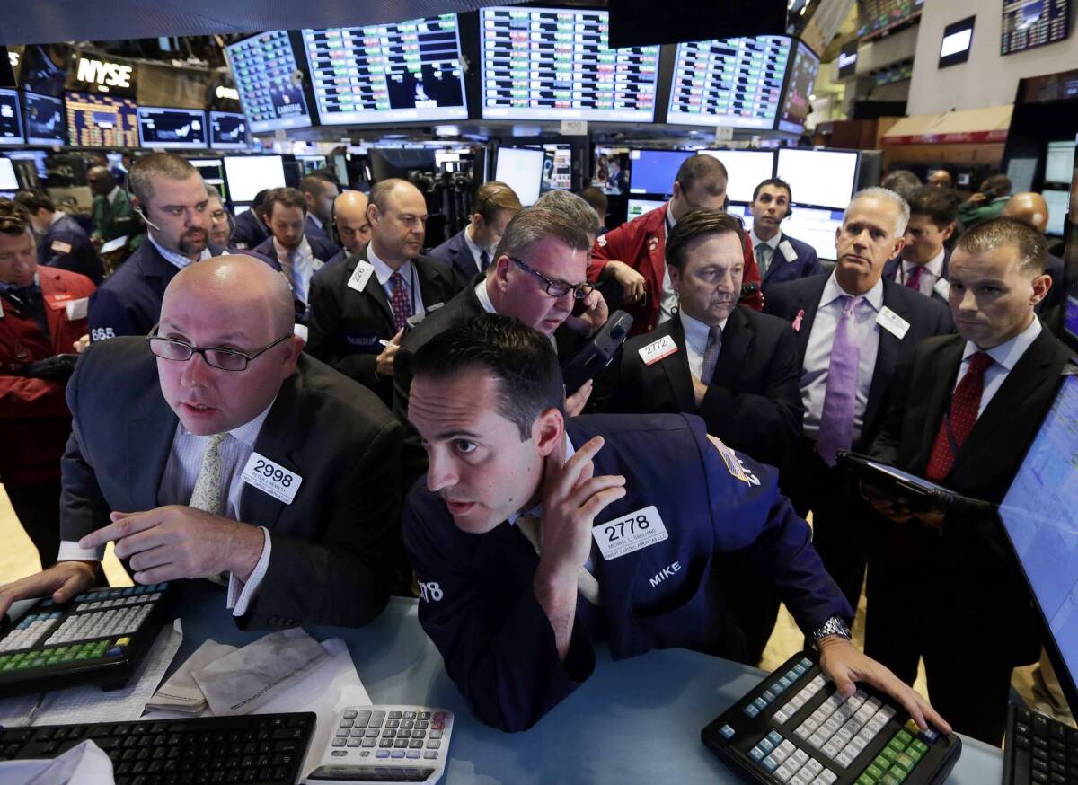 Traders work on the floor of the New York Stock Exchange, where stocks rose sharply on hopes that the budget impasse in Washington may break soon.