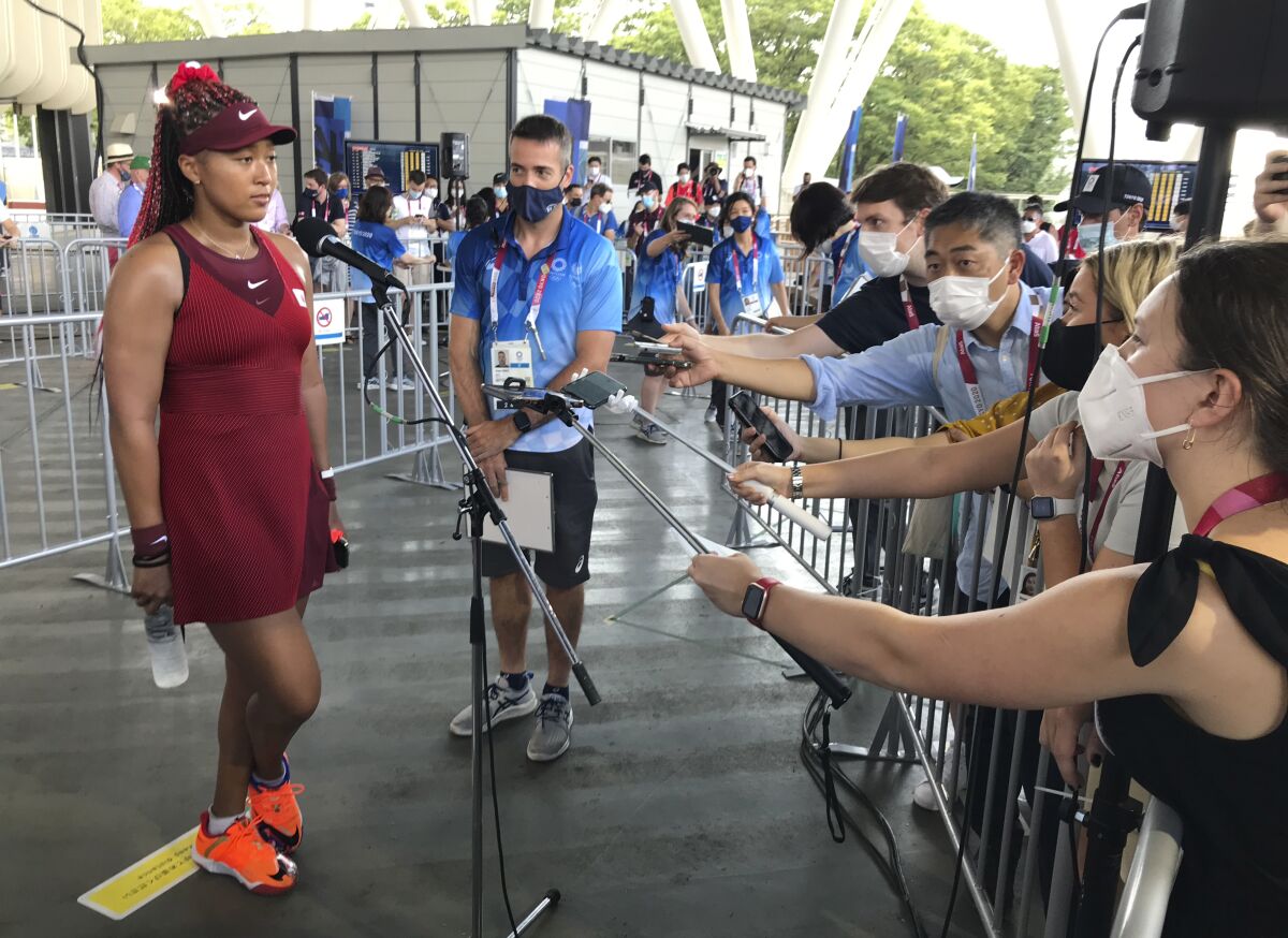 Naomi Osaka speaks with journalists after her first-round singles win.
