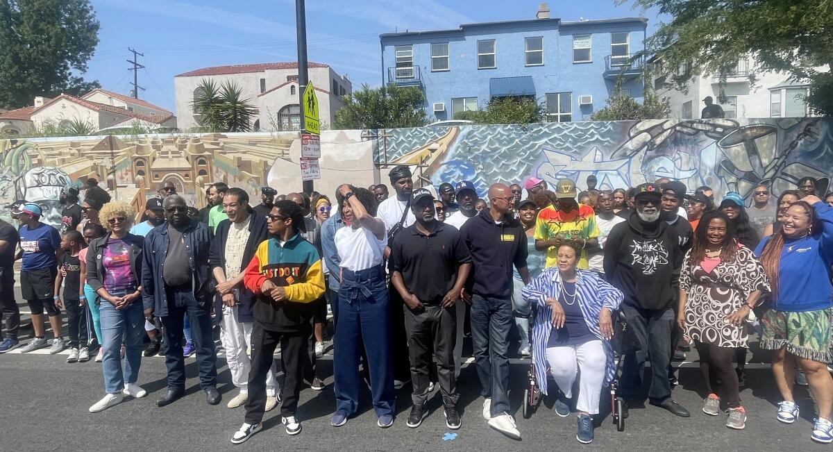 Community members pose for a photograph at the "Pull Up at the Wall" event Saturday in South L.A.