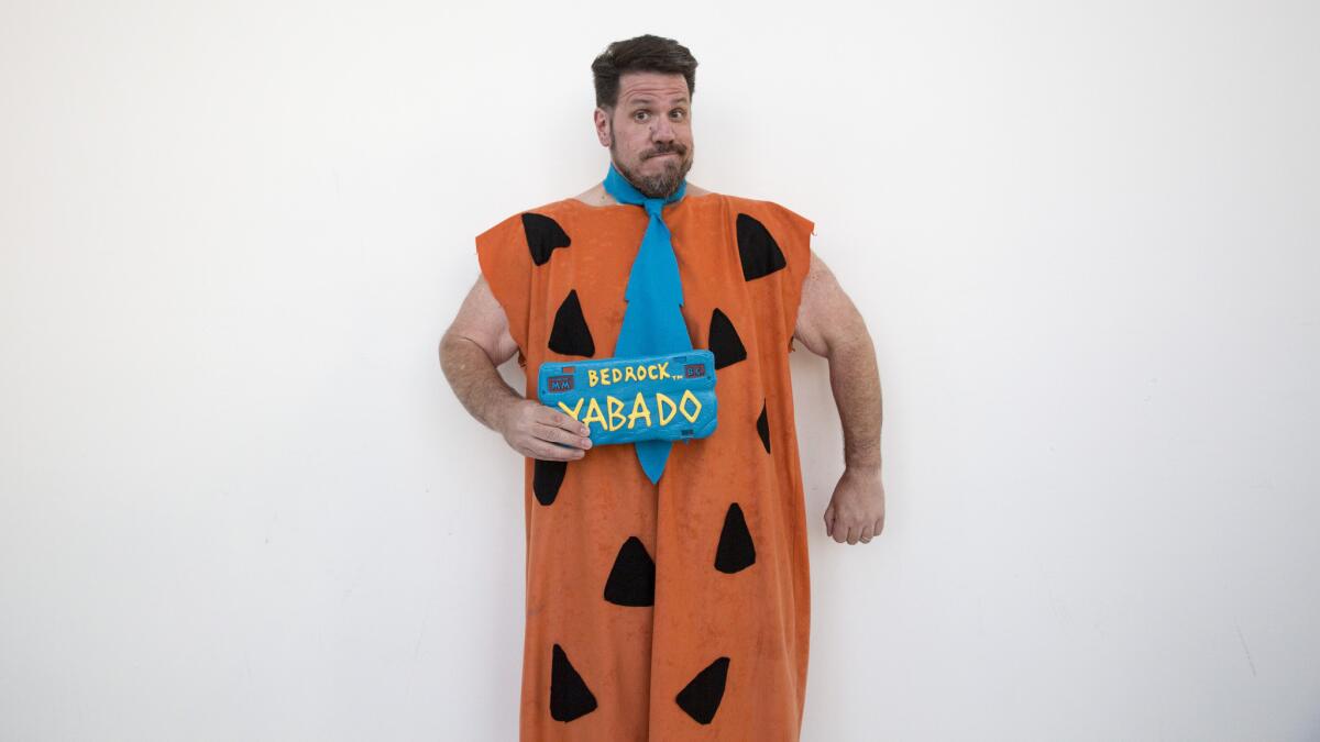 Sebastian Sanzberro, 49, of Corona, wears a homemade Fred Flintstone costume made by his wife.