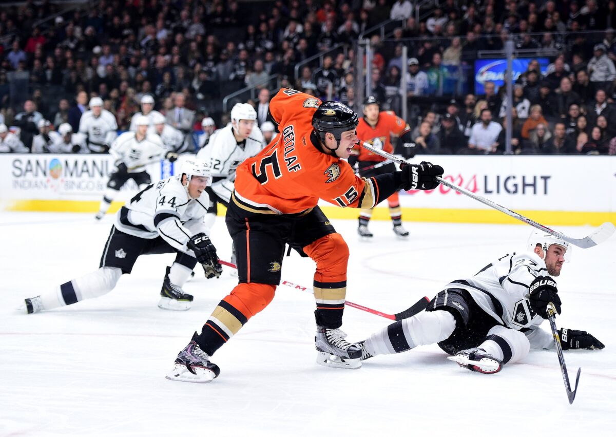 Ducks captain Ryan Getzlaf (15) unleashes a shot past sliding Kings defenseman Alec Martinez for a goal in the first period.