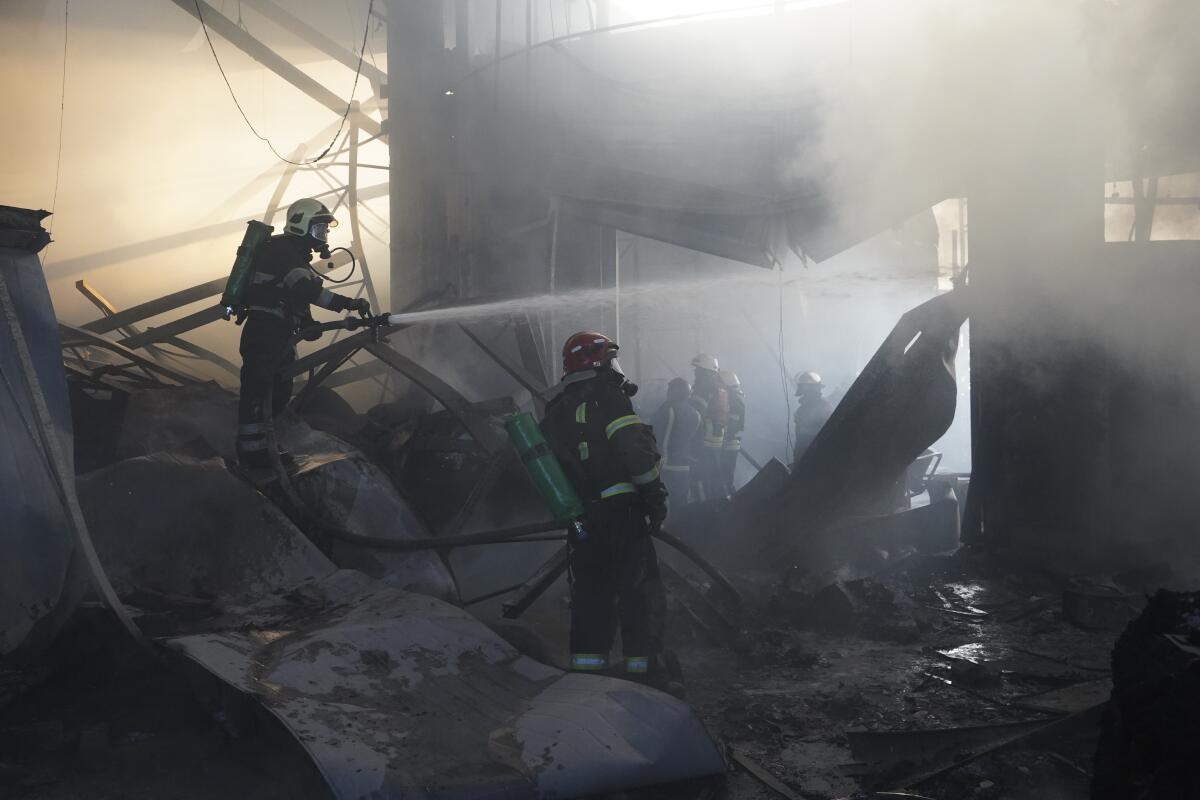 Firefighters put out a fire after Russian attack in Kharkiv, Ukraine.