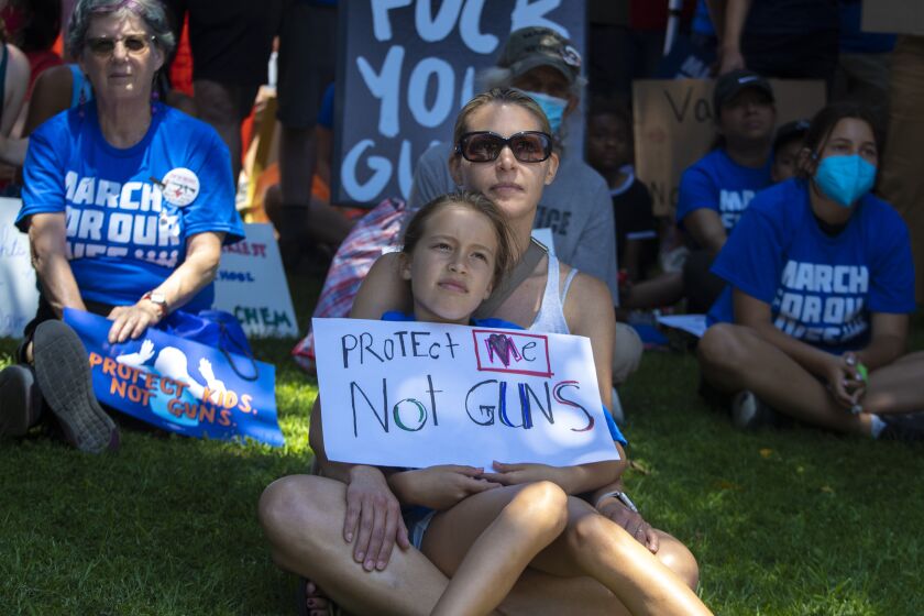 Los Angeles, CA - June 11: Katie Villegas and daughter Siena listen to speakers during March for our Lives against gun violence downtown on Saturday, June 11, 2022 in Los Angeles, CA. (Brian van der Brug / Los Angeles Times)