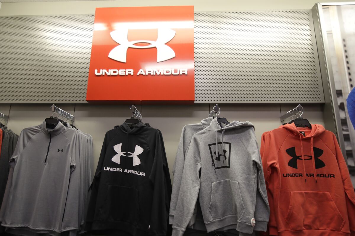 FILE - In this Nov. 29, 2019, file photo Under Armour clothes are displayed at a Kohl's store in Colma, Calif. Sportswear company Under Armour has settled with the Securities and Exchange Commission to pay $9 million in fines related to misleading its revenue growth to investors from the third quarter of 2015 through the fourth quarter of 2016, the agency said Monday, May 3, 2021. (AP Photo/Jeff Chiu, File)