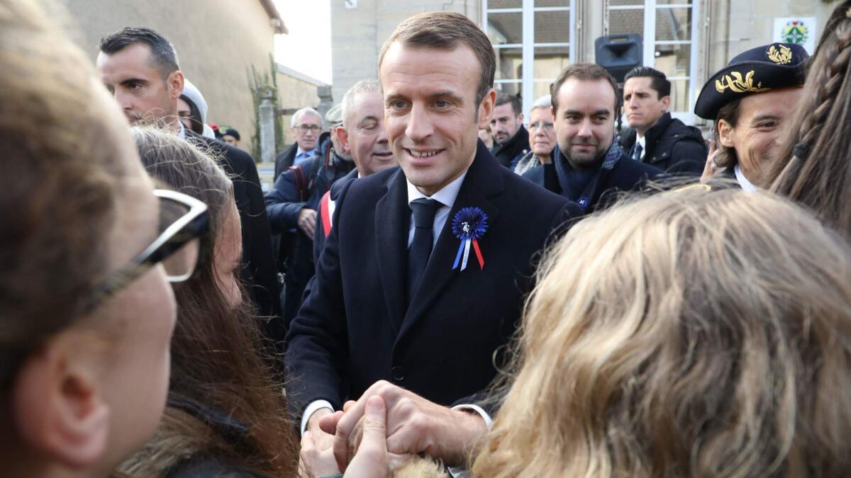 French President Emmanuel Macron, center, meets residents as he arrives in Les Eparges on Nov. 6, 2018.