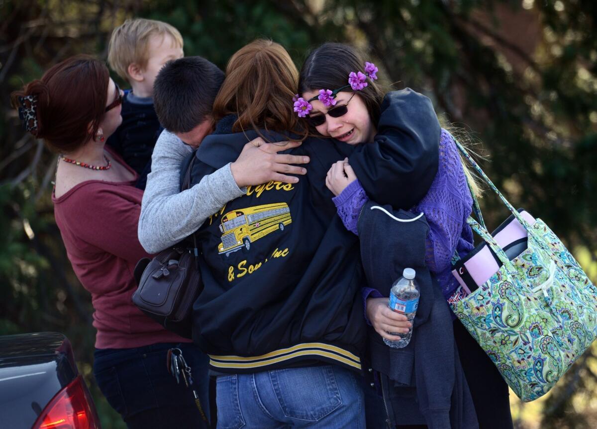 Parents and students embrace near Franklin Regional High School after students were stabbed at the school April 9.