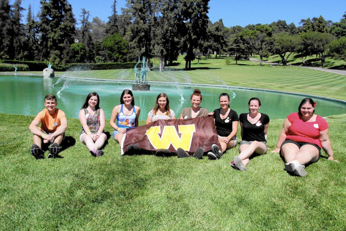 Students from Western Michigan University, on the last of a nine-day tour trip following Walt Disney's path to California, stop at Forest Lawn Memorial Park in Glendale, where the Disney creator is buried. The students, left to right, Brendan Schneider, 19, Emily Theresa Fackler, 19, Kristen Stowell, 20, Katelyn Drummond, 19, MacKayla Myszka, 20, Megan Schaefer, 21, Hannah Truckenbrod, 19 and Carly Dauer, 21, dropped off flowers at Disney's final resting place in the memorial park.