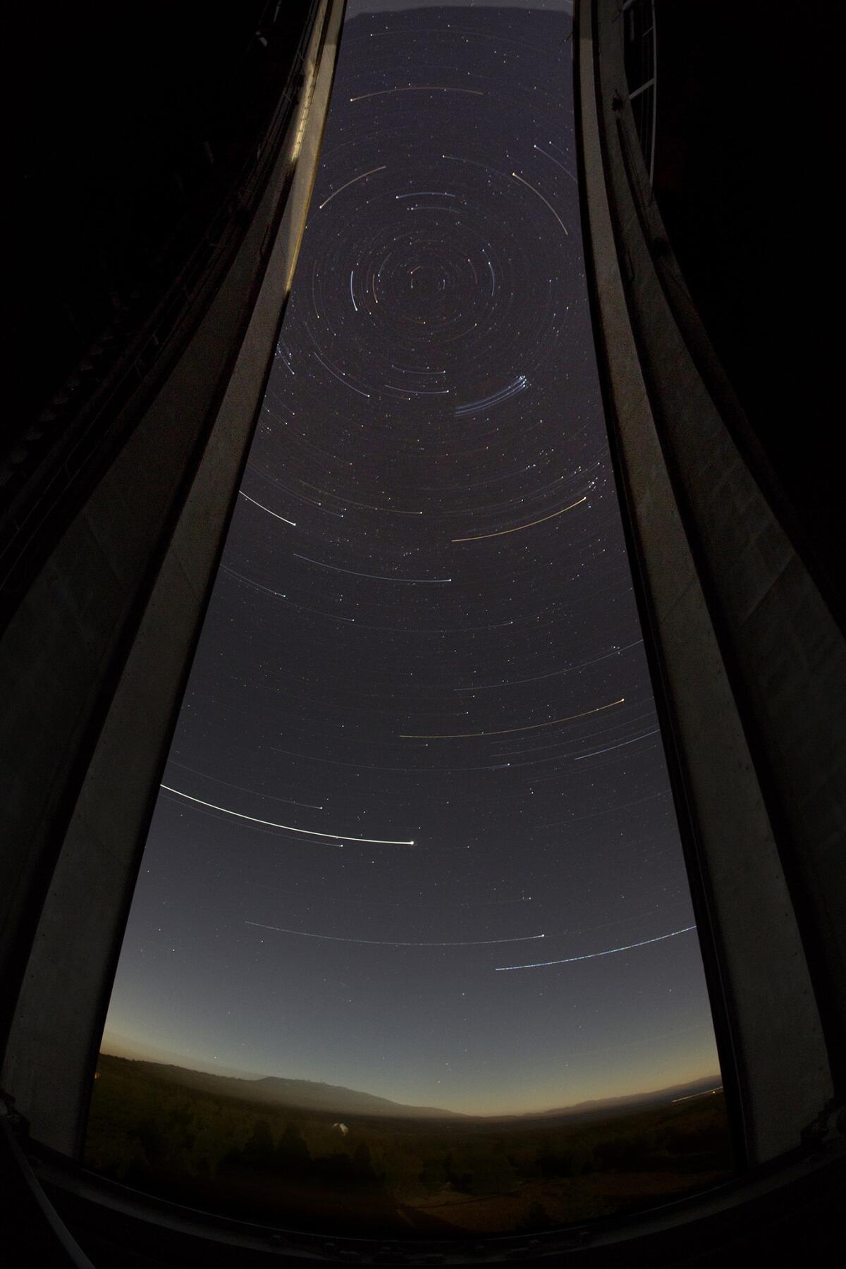 Stars in the southern sky appear as streaks during a 50-second exposure while the Palomar Observatory dome rotates.