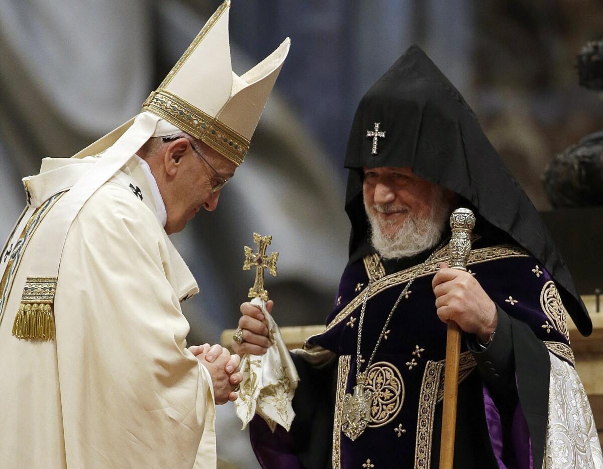 Pope Francis, left, is greeted by the head of Armenia's Orthodox Church, Karekin II, right, during an Armenian rite Mass in St. Peter's Basilica on April 12.