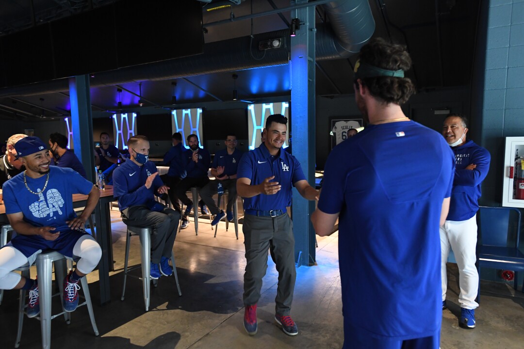 Dodgers clubhouse attendant Chico Herrera receives his World Series ring from outfielder Cody Bellinger